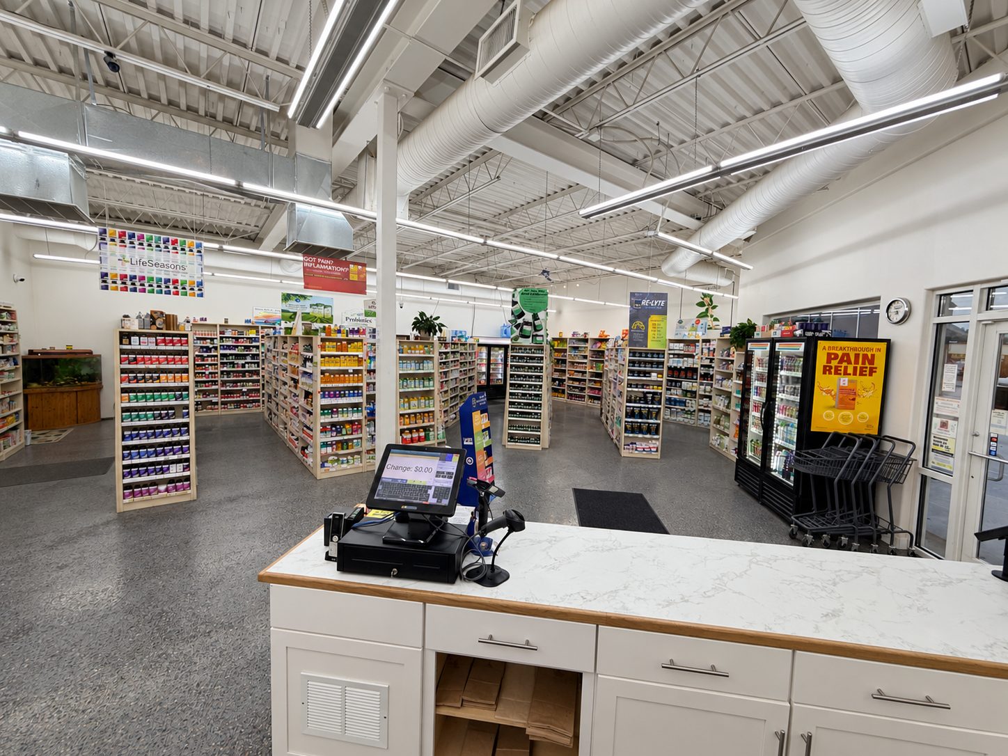 The Nature's Nook checkout counter with aisles of supplements and the drink coolers behind it